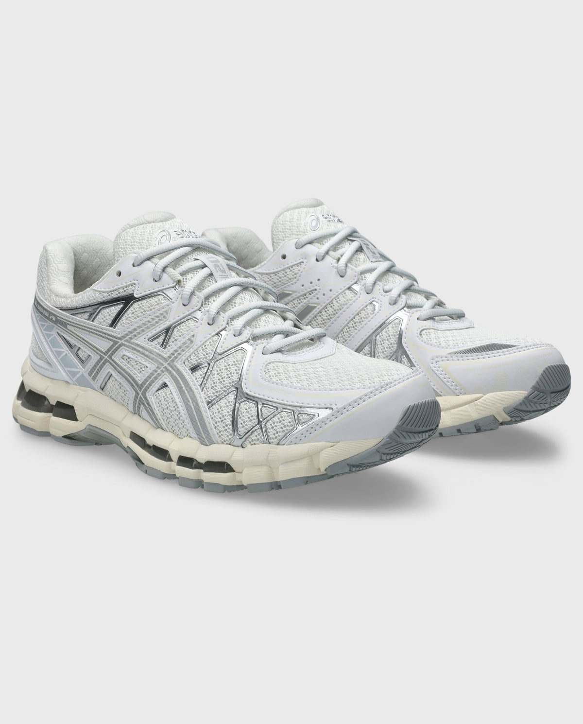 Witte Asics hardloopschoenen, schuin zijaanzicht met geperforeerd mesh en zilveren logopanelen.