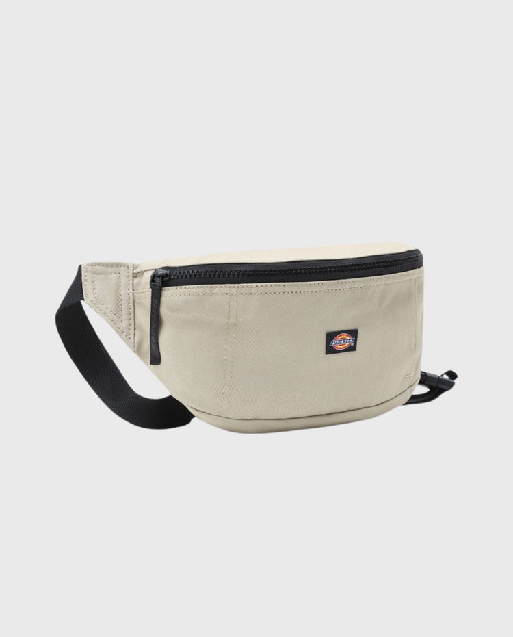 Beige crossbody tas met zwarte riem, ronde vorm en rits