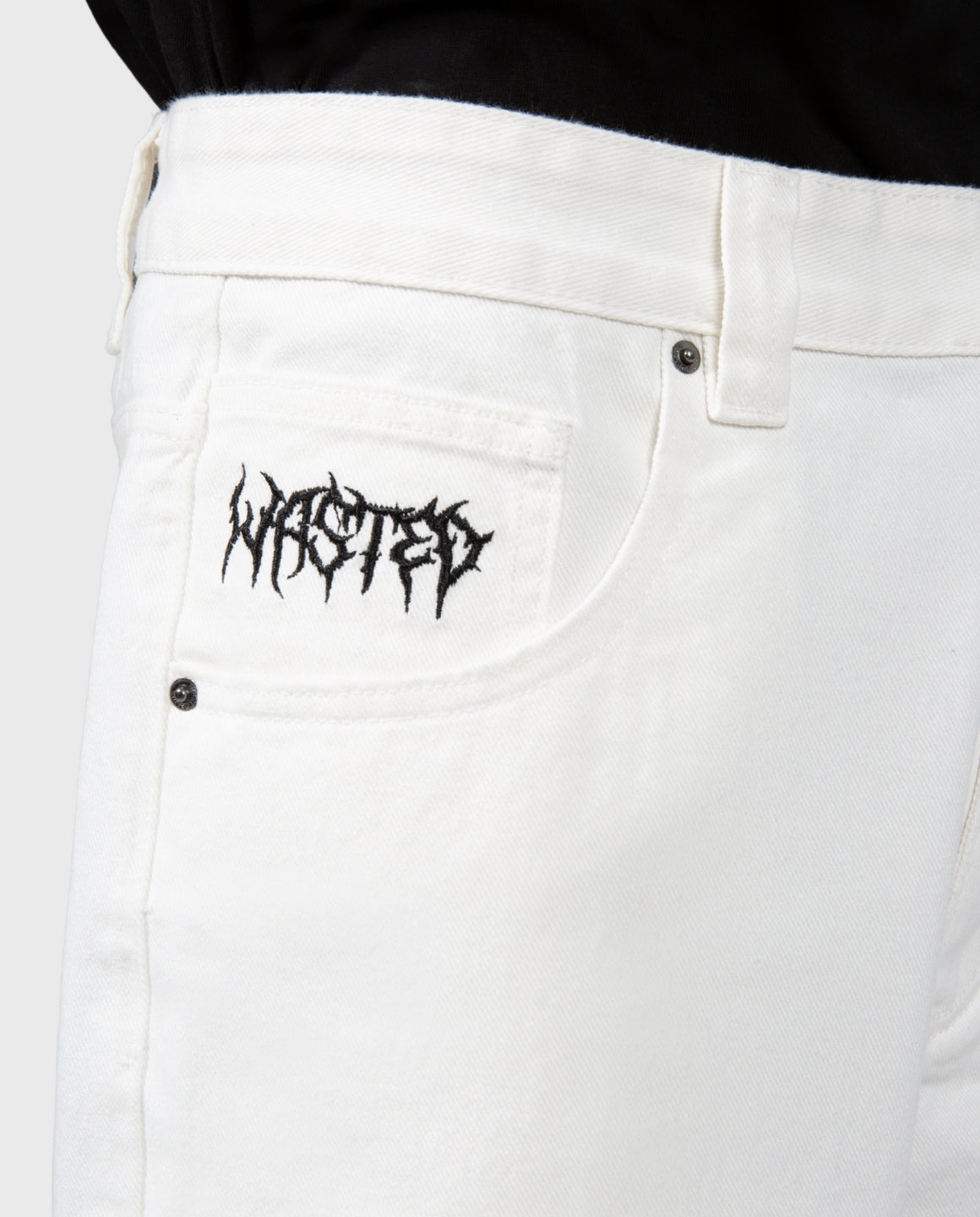 Casper broek off-white close-up: achterzak met zwart logo en knoop
