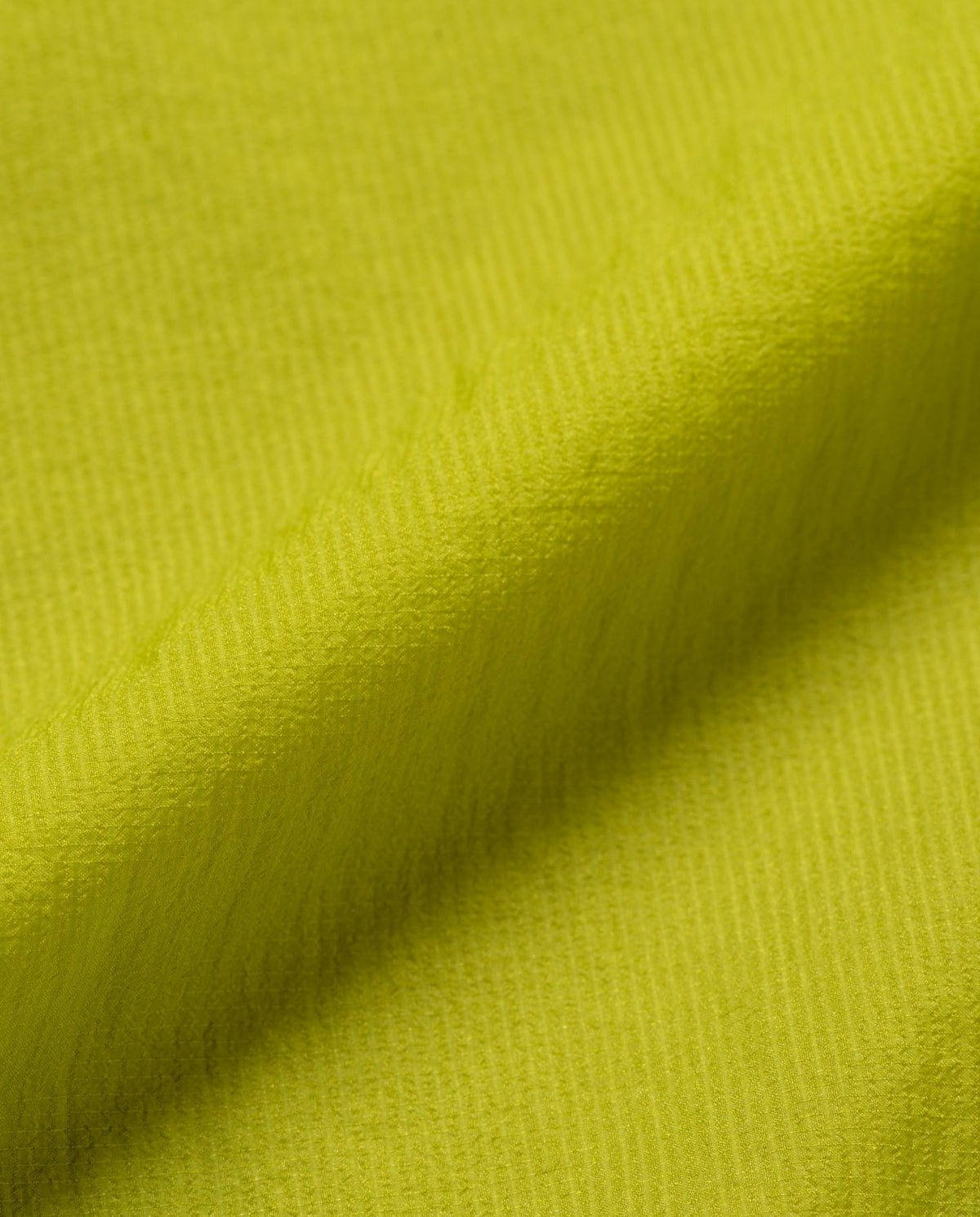 Kiwi-groene jasstof met fijn geweven textuur