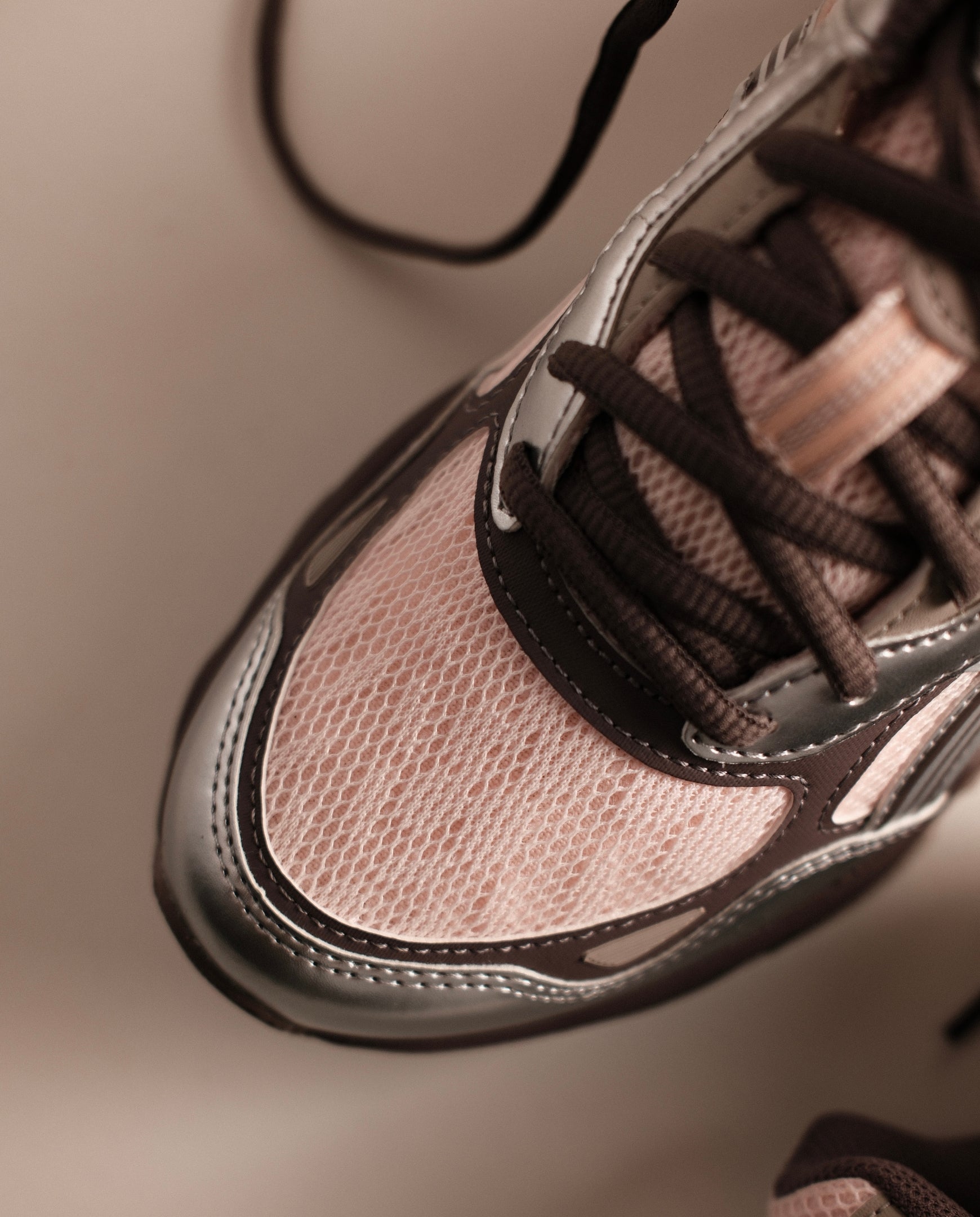 Roze en zilveren sneaker met veters en reflecterende rand rond de neus