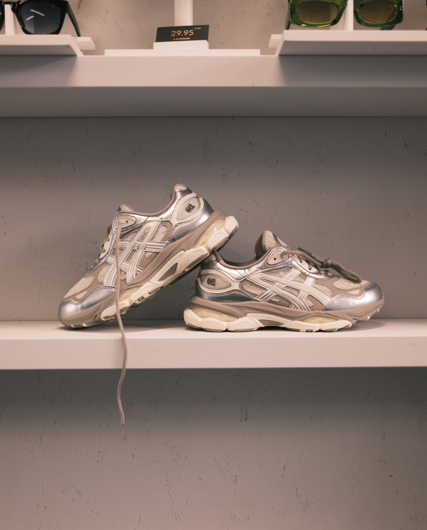 ASICS Gel-NYC 2.0 sneakers, smoke grey en zilver, twee paar op plank, met veters